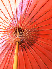 Closeup the structure of the red beach umbrella old made of wooden for protected sunlight.