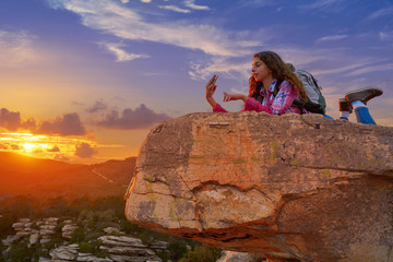 Hiker teen girl selfie phone on peak of mountain