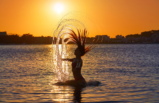 Girl Flipping Hair Flip At Sunset Beach