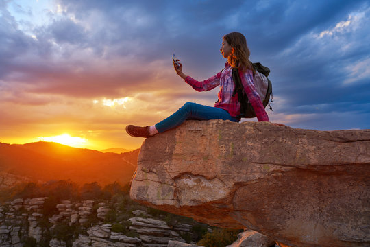 Hiker teen girl selfie phone on peak of mountain