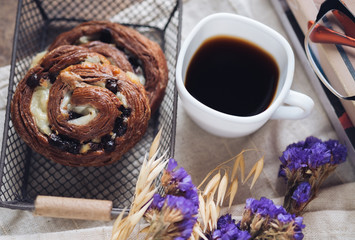 Chocolate danish bread with a cup of black coffee