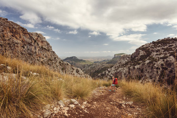 A tourist girl on a trek in mountains of Mallorca