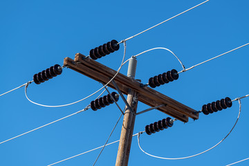 Power lines and insulators with a clear blue sky