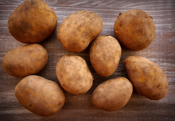 Organic potatoes on wooden board
