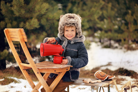 Child in winter. Fun little boy in the snow. The child is playing outside. Winter background. Beautiful, original winter photos.