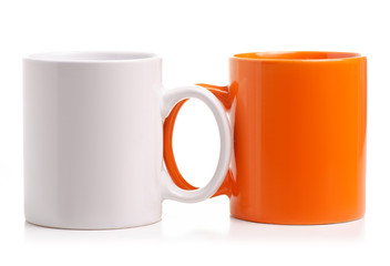 Two cups mug white orange on white background isolation