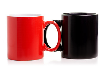 Two cups mug red black on white background isolation