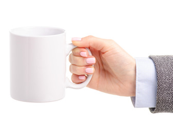 White cup mug in female hand on white background isolation