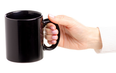 Black cup mug in female hand on white background isolation