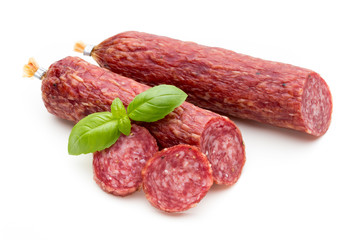 Salami smoked sausage, basil leaves and peppercorns isolated on white background.