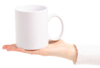 White cup mug in female hand on white background isolation