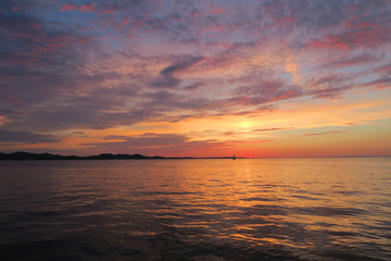 Obraz premium amazing meditation sunset on the Adriatic Sea with a sailboat