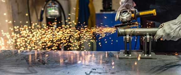 worker at work with his grinder in a metalworking industry