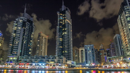 Fototapeta na wymiar View of Dubai Marina Towers and canal in Dubai night timelapse hyperlapse