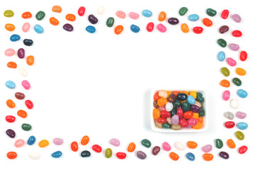 Jelly bean sweets frame and in a rectangular bowl isolate flat lay