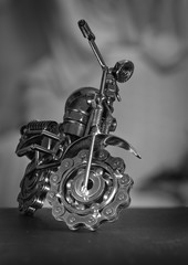 Close up (Macro) of Handmade metal toy motorcycle/motorbike made out of scrap metal pieces with short depth of view