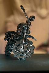 Close up (Macro) of Handmade metal toy motorcycle/motorbike made out of scrap metal pieces with short depth of view