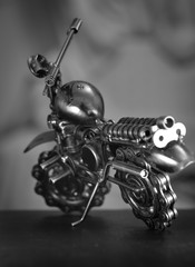 Close up (Macro) of Handmade metal toy motorcycle/motorbike made out of scrap metal pieces with short depth of view