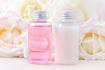 Fototapeta na wymiar natural cosmetic bottles with fresh rose flowers, organic beauty treatment