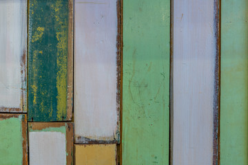 Colored wooden boards in the colors white, green, yellow.