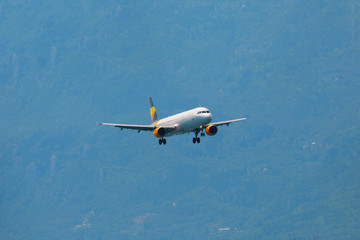 A passenger plane flying in the blue sky, preparing for landing