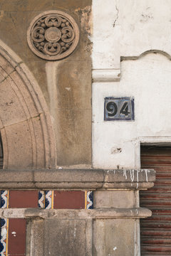Board with 94 house number on wall