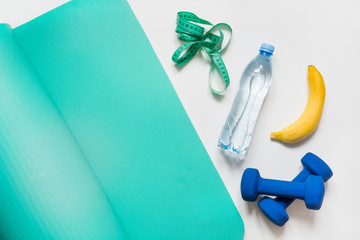Sport equipment. Creative concept of sport, food and fitness equipments on white with copy space.