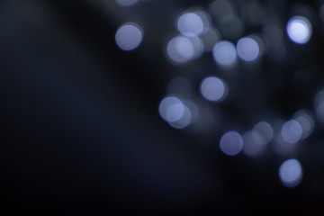 Blurred defocused silver, white and blue bright light, shiny spots bokeh background