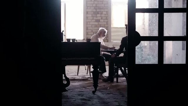 Soldier of the Russian army interrogates a suspect, an elderly man with a beard, under pain of execution, signs papers, the injustice of the NKVD, cynicism of the soldiers, the cruelty of the USSR