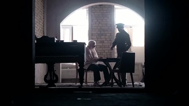 Soldier of the Russian army interrogates a suspect, an elderly man with a beard, under pain of execution, signs papers, the injustice of the NKVD, cynicism of the soldiers, the cruelty of the USSR