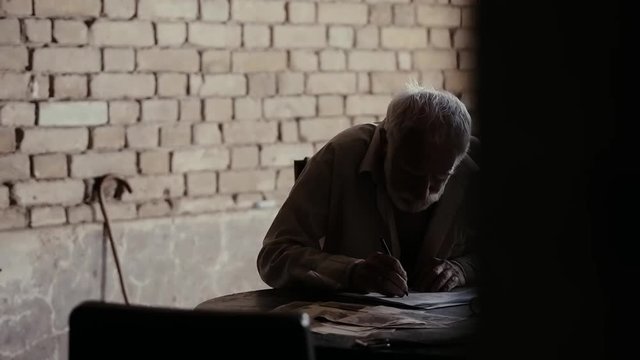 Soldier of the Russian army interrogates a suspect, an elderly man with a beard, under pain of execution, signs papers, the injustice of the NKVD, cynicism of the soldiers, the cruelty of the USSR