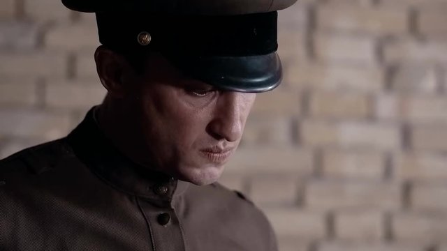 Soldier of the Russian army interrogates a suspect, an elderly man with a beard, under pain of execution, signs papers, the injustice of the NKVD, cynicism of the soldiers, the cruelty of the USSR