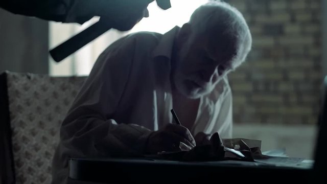 Soldier of the Russian army interrogates a suspect, an elderly man with a beard, under pain of execution, signs papers, the injustice of the NKVD, cynicism of the soldiers, the cruelty of the USSR