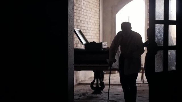 A rich old man in his castle considers old money, old times of the beginning of the 20th century, a wealthy, bearded man inside an old gloomy house, a cinematic picture, a mysterious castle of writer