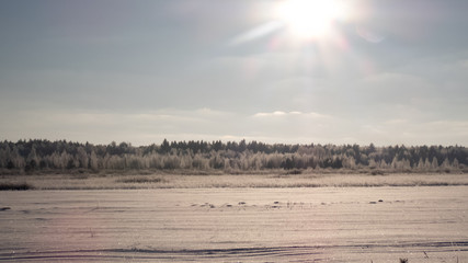 winter landscape in rising sun rays
