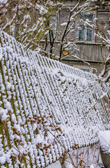 Winter sketches. Fluffy snow on houses, fences and other buildings.