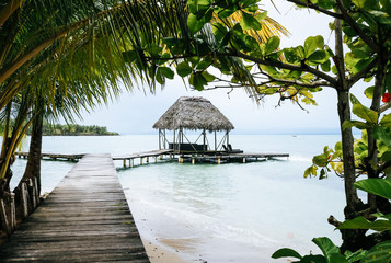 Quay leading to a little hat in the turqoise waters of the Caribbean coast on Bocas del Toro island, Panama
