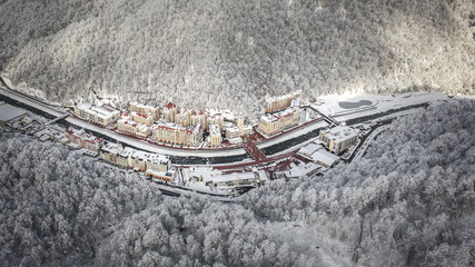 The Rosa Khutor resort in Sochi, Krasnaya Polyana Town hall with clock, Mzymta river, hotels and restaurants on the river Rest in the mountains, vacation in nature Aerial photography with quadrocopter © Ivan_vislov_nadsochi
