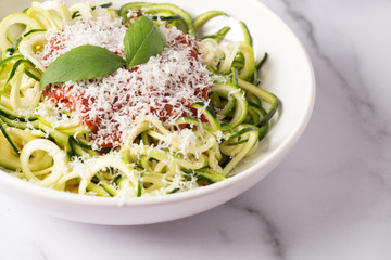 Zucchini Pasta Topped with Parmesean and Tomato Sauce