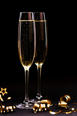Two glasses of champagne full size on black background.