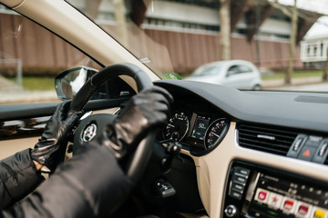 STRASBOURG, FRANCE - DEC 26, 2018: Woman driving Skoda Octavia Czech car wearing leather gloves in the center of Strasbourg, France with 50 km per hour 