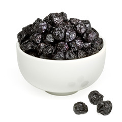 Sun dried blueberries heap or pile in bowl isolated on white background