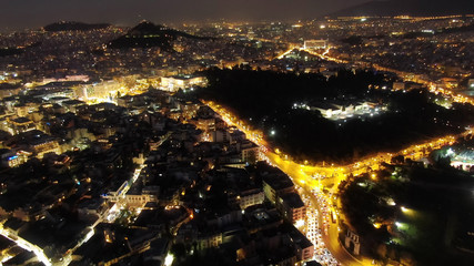 Aerial drone detail night shot of iconic city of Athens with dazzling lights, Athens historic centre, Attica, Greece