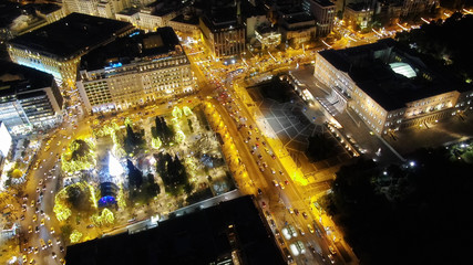 Aerial drone night shot from famous Syntagma square illuminated during Christmas festivities and Greek Parliament  building, Athens historic centre, Attica, Greece