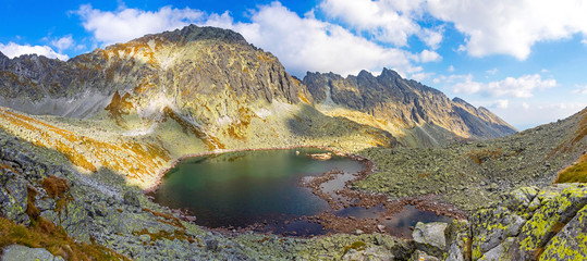 Hiking in High Tatras Mountains (Vysoke Tatry), Slovakia. Panoramic view of Lake over Skok waterfall (Slovak: Pleso nad Skokom) (1801m). Mount Satan (2421m) on the background © katatonia