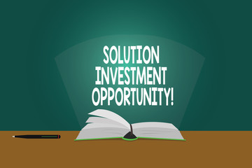 Conceptual hand writing showing Solution Investment Opportunity. Business photo showcasing Strategies before undertaking a business Color Pages of Book on Table with Pen and Light Beam Glaring