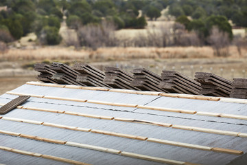 Cement Roofing Tiles being stacked on Rooftop