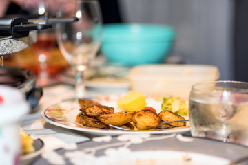 delicious hot baked potato wedges as traditional garnish or side dish on christmas dinner table