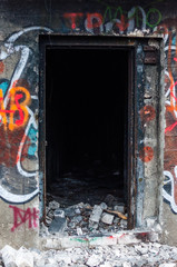 Entrance to abandoned concrete bunker built during the Second World War right in a hill near the center of Vilnius. Walls painted and decorated with graffiti