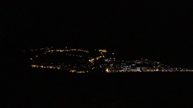 View on Bedesten Alanya fortress residential buildings lights from Alanya beach. Night survey. Turkey.